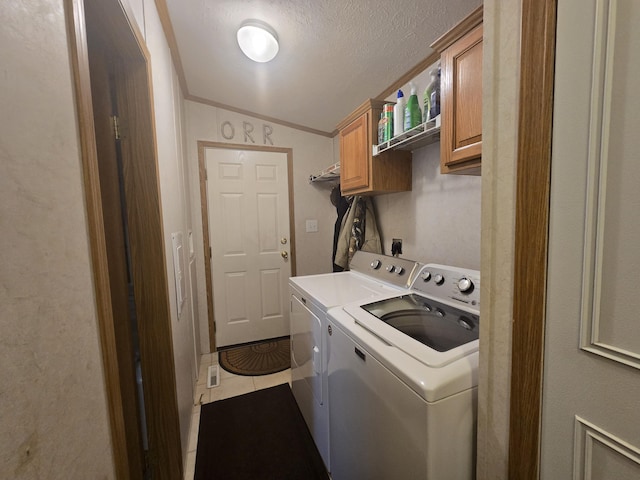 5844 Keipinger Trl, Grayling, MI 49738 - laundry room with cabinet space, separate washer and dryer, crown molding, tile patterned floors, and a textured ceiling
