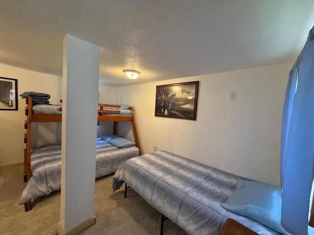 10117 M-18, Gladwin, MI 48624 - bedroom featuring a textured ceiling and carpet flooring