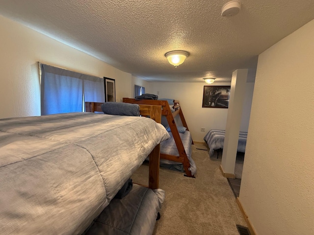 10117 M-18, Gladwin, MI 48624 - carpeted bedroom featuring a textured ceiling