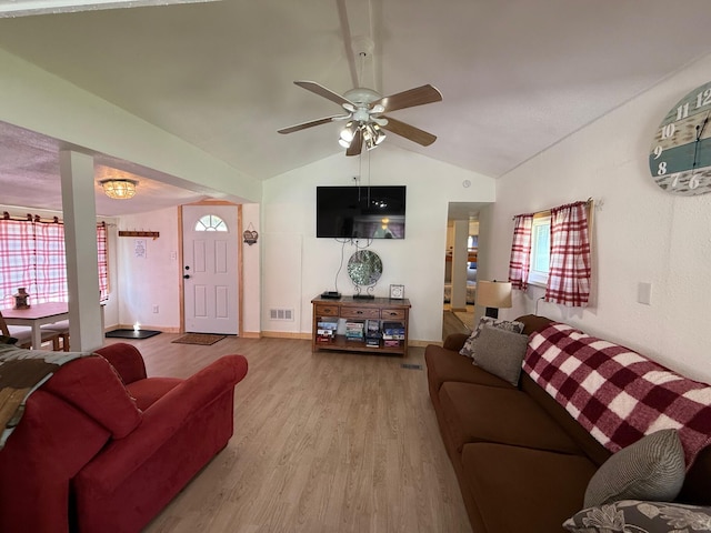 10117 M-18, Gladwin, MI 48624 - living area with vaulted ceiling, wood finished floors, ceiling fan, and baseboards