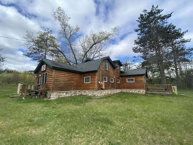 5626 Smith Rd, Lewiston, MI 49756 - view of side of property with a lawn, a deck, roof with shingles, and log veneer siding