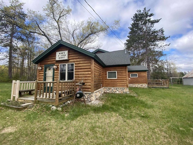 5626 Smith Rd, Lewiston, MI 49756 - rear view of house featuring a yard, a deck, roof with shingles, and log veneer siding
