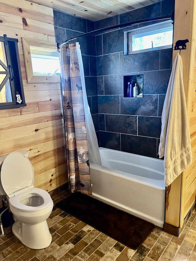 468 Pine Oak Trl, Grayling, MI 49738 - full bath with brick patterned floors, wood walls, shower / bath combination with curtain, and toilet