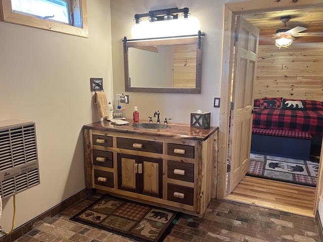 468 Pine Oak Trl, Grayling, MI 49738 - bathroom featuring brick patterned floors, baseboards, a ceiling fan, vanity, and wooden walls