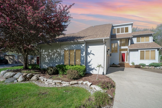 118 Harbor Ct, Houghton Lake, MI 48629 - view of front of house featuring a shingled roof, driveway, and entry steps