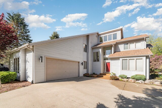 118 Harbor Ct, Houghton Lake, MI 48629 - view of front of home featuring driveway, a garage, and a shingled roof