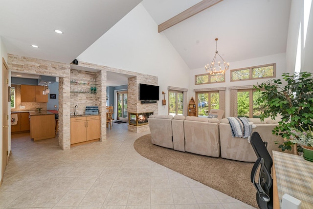 118 Harbor Ct, Houghton Lake, MI 48629 - living area featuring a multi sided fireplace, high vaulted ceiling, light tile patterned floors, a chandelier, and beam ceiling