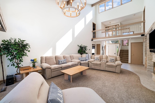 118 Harbor Ct, Houghton Lake, MI 48629 - living room featuring a chandelier, a high ceiling, stairs, and a stone fireplace