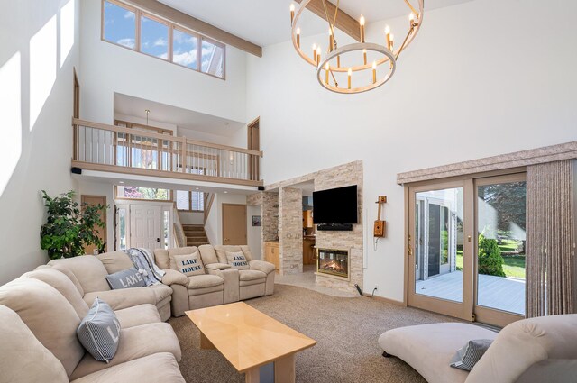 118 Harbor Ct, Houghton Lake, MI 48629 - living room featuring a towering ceiling, a chandelier, healthy amount of natural light, stairway, and carpet floors