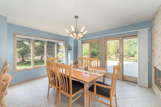 118 Harbor Ct, Houghton Lake, MI 48629 - dining space featuring a chandelier, healthy amount of natural light, and light tile patterned floors