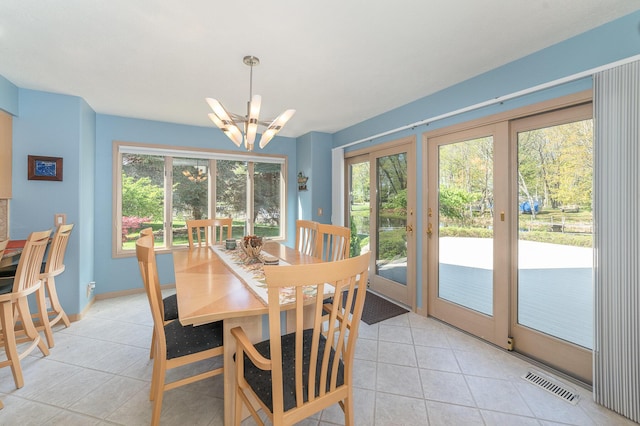 118 Harbor Ct, Houghton Lake, MI 48629 - dining space featuring a chandelier, light tile patterned floors, and healthy amount of natural light