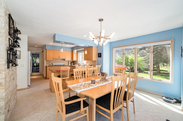 118 Harbor Ct, Houghton Lake, MI 48629 - dining space with light tile patterned floors, a chandelier, and baseboards