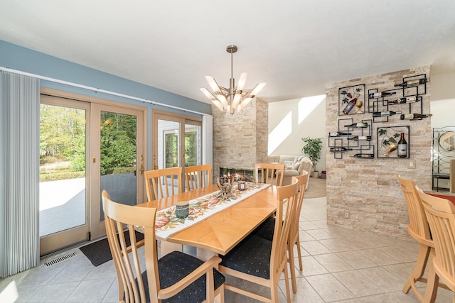 118 Harbor Ct, Houghton Lake, MI 48629 - dining space featuring a chandelier and light tile patterned floors