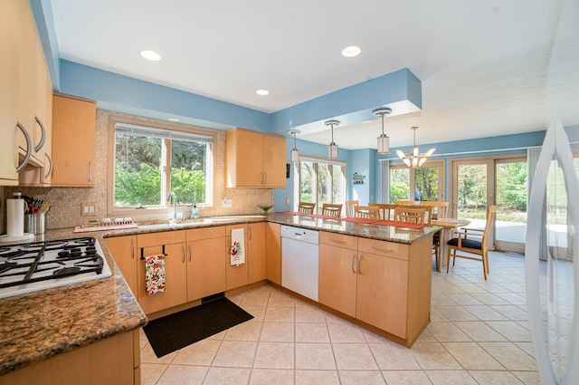 118 Harbor Ct, Houghton Lake, MI 48629 - kitchen with white appliances, light brown cabinetry, a peninsula, a sink, and plenty of natural light