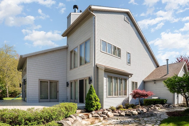 118 Harbor Ct, Houghton Lake, MI 48629 - back of house featuring a chimney