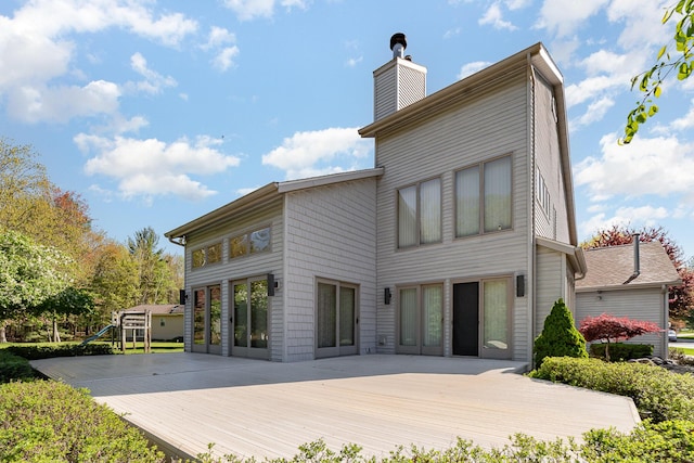118 Harbor Ct, Houghton Lake, MI 48629 - rear view of property with a deck and a chimney