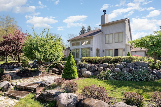 118 Harbor Ct, Houghton Lake, MI 48629 - back of property with a chimney
