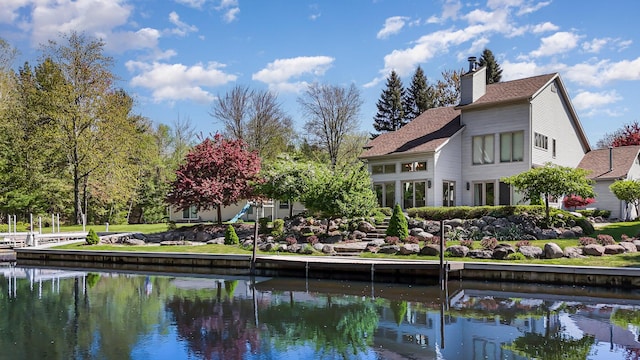 118 Harbor Ct, Houghton Lake, MI 48629 - back of house featuring a chimney, a water view, and roof with shingles