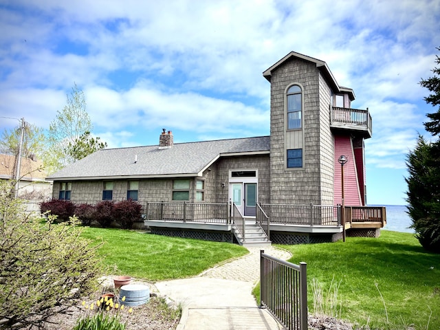 2215 N Partridge Point Rd, Alpena, MI 49707 - rear view of house featuring a deck, a lawn, and a chimney
