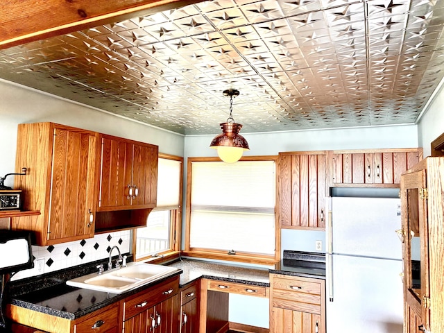 2215 N Partridge Point Rd, Alpena, MI 49707 - kitchen with freestanding refrigerator, a sink, dark countertops, an ornate ceiling, and decorative backsplash
