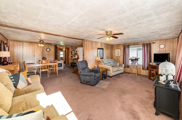 125 Wickham Ave, Houghton Lake, MI 48629 - carpeted living room with a ceiling fan and wooden walls