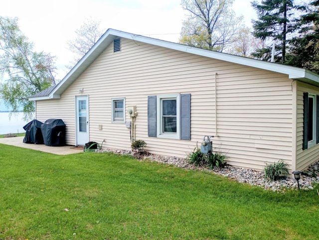 12243 E Houghton Lake Dr, Houghton Lake, MI 48629 - back of property featuring a lawn