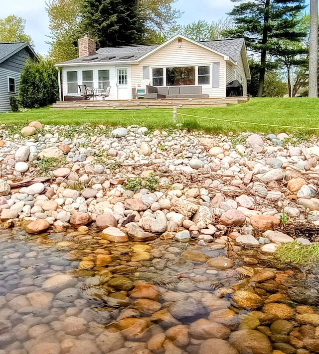 12243 E Houghton Lake Dr, Houghton Lake, MI 48629 - back of house featuring a chimney