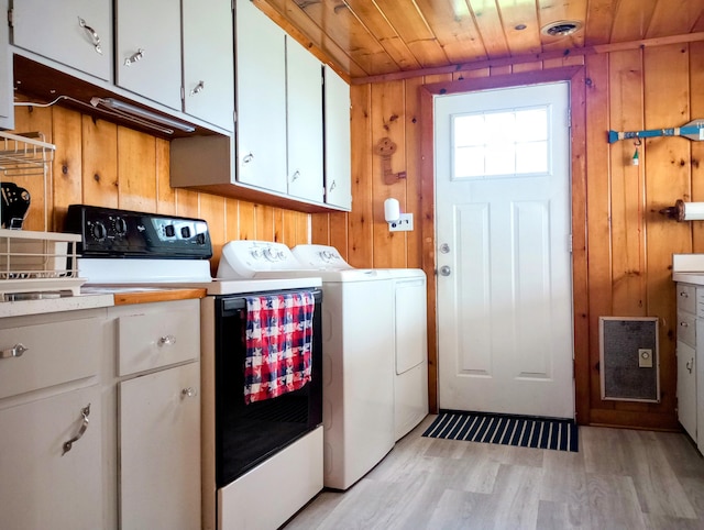 12243 E Houghton Lake Dr, Houghton Lake, MI 48629 - laundry area with washing machine and dryer, wooden walls, cabinet space, light wood-style flooring, and wood ceiling