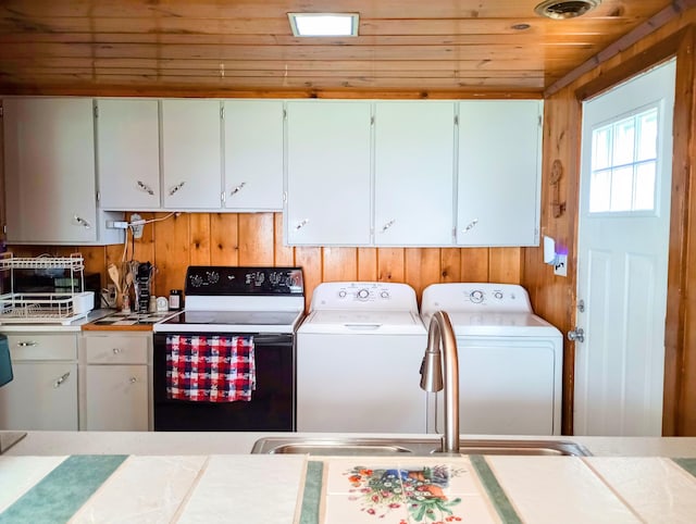 12243 E Houghton Lake Dr, Houghton Lake, MI 48629 - laundry room with washer and dryer, wooden ceiling, and wood walls