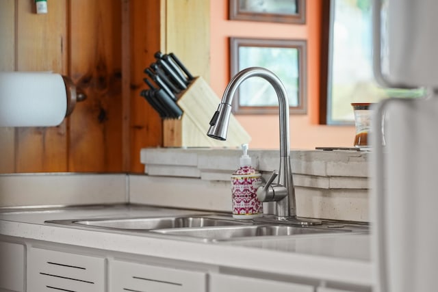 12243 E Houghton Lake Dr, Houghton Lake, MI 48629 - kitchen view of a sink, light countertops, and white cabinetry