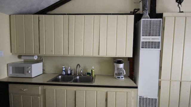 110 Mulberry Ln, Roscommon, MI 48653 - kitchen featuring white microwave, a sink, a heating unit, and light countertops