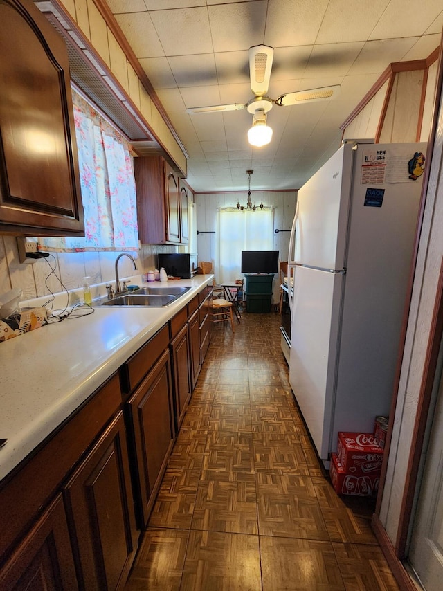 8881 Artesia Beach Rd, Saint Helen, MI 48656 - kitchen featuring freestanding refrigerator, light countertops, a sink, dark floors, and range