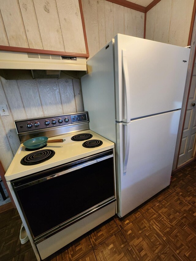 8881 Artesia Beach Rd, Saint Helen, MI 48656 - kitchen featuring electric range, under cabinet range hood, freestanding refrigerator, wood walls, and light countertops