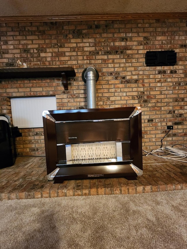 8881 Artesia Beach Rd, Saint Helen, MI 48656 - detailed view of carpet flooring and brick wall