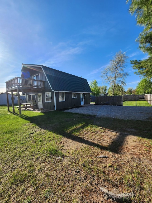8881 Artesia Beach Rd, Saint Helen, MI 48656 - view of side of property with a wooden deck and metal roof