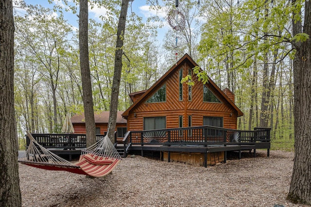 215 Garfield Blvd, Roscommon, MI 48653 - view of front of home featuring log veneer siding and a wooden deck