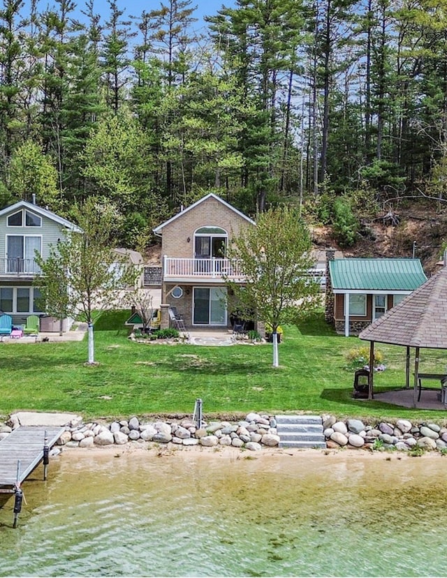 13042 Silver Lake Resort Rd, Wolverine, MI 49799 - dock area featuring a lawn, a gazebo, a water view, and a patio
