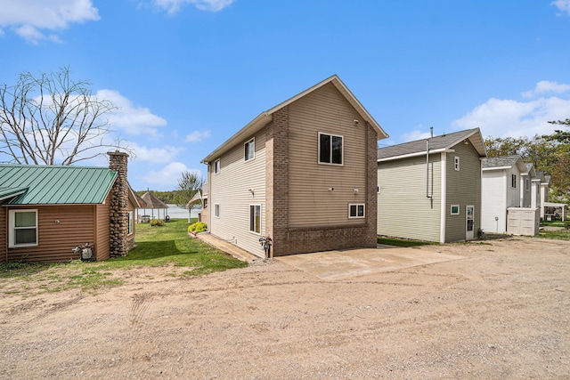 13042 Silver Lake Resort Rd, Wolverine, MI 49799 - rear view of house with a chimney