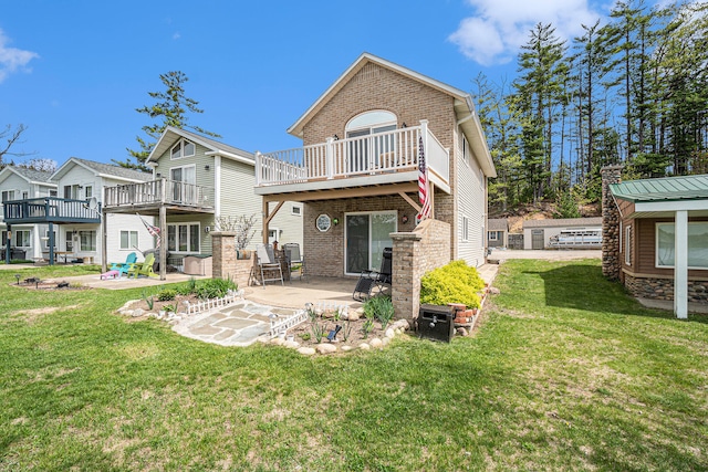 13042 Silver Lake Resort Rd, Wolverine, MI 49799 - rear view of property with a patio, brick siding, a balcony, and a yard