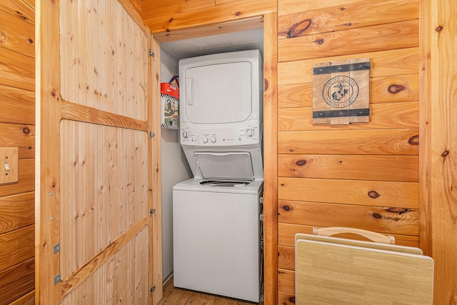 13042 Silver Lake Resort Rd, Wolverine, MI 49799 - laundry room featuring stacked washer / drying machine and wood finished floors