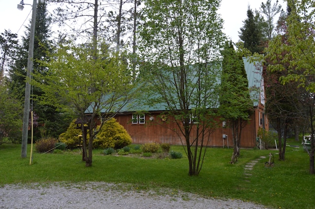 4163 Hanson Rd, Lewiston, MI 49756 - view of side of property featuring a yard, a barn, and an outdoor structure