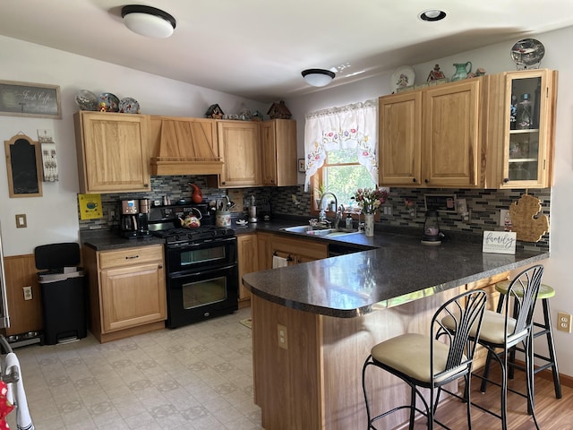 676 N Poor Farm Rd, Harrisville, MI 48740 - kitchen featuring range with two ovens, a sink, custom range hood, a peninsula, and dark countertops