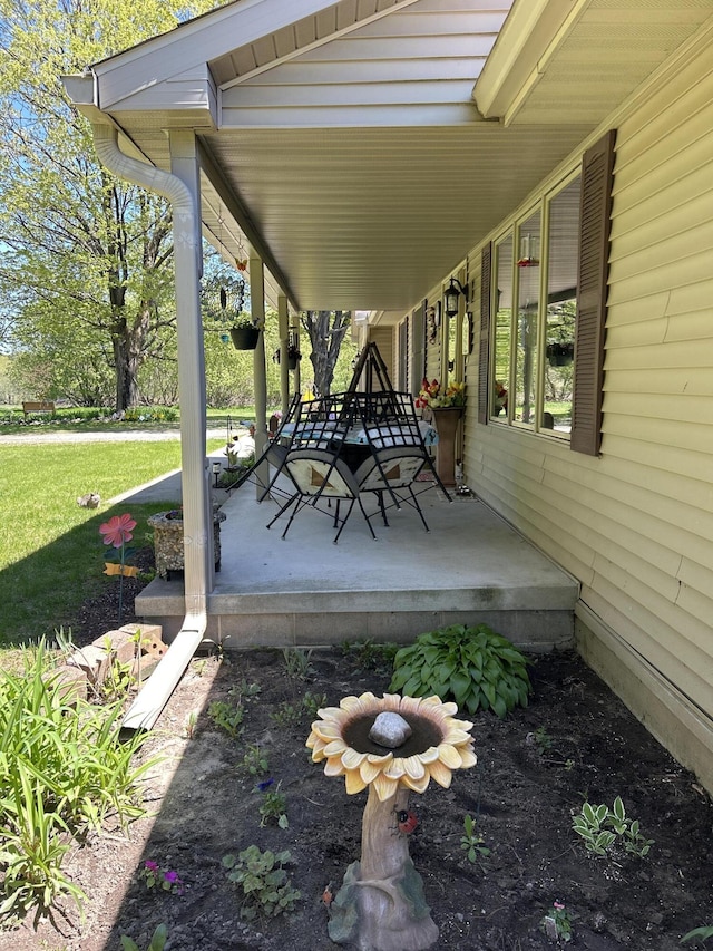 676 N Poor Farm Rd, Harrisville, MI 48740 - covered porch with a yard