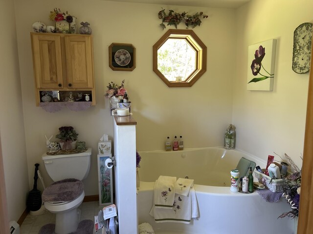 676 N Poor Farm Rd, Harrisville, MI 48740 - full bathroom featuring toilet, a garden tub, and baseboard heating