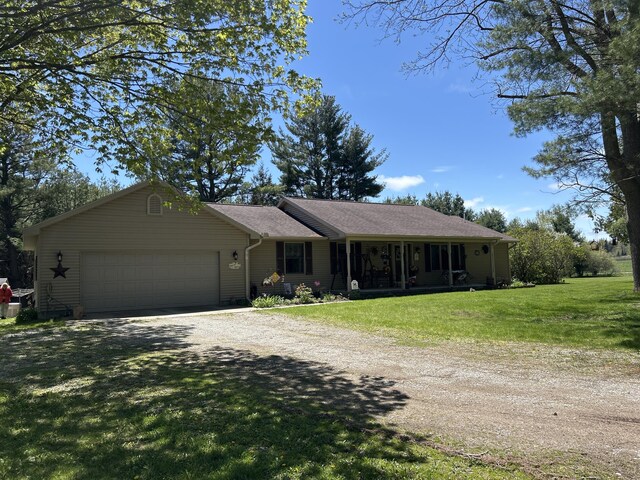 676 N Poor Farm Rd, Harrisville, MI 48740 - ranch-style home featuring driveway, an attached garage, and a front yard
