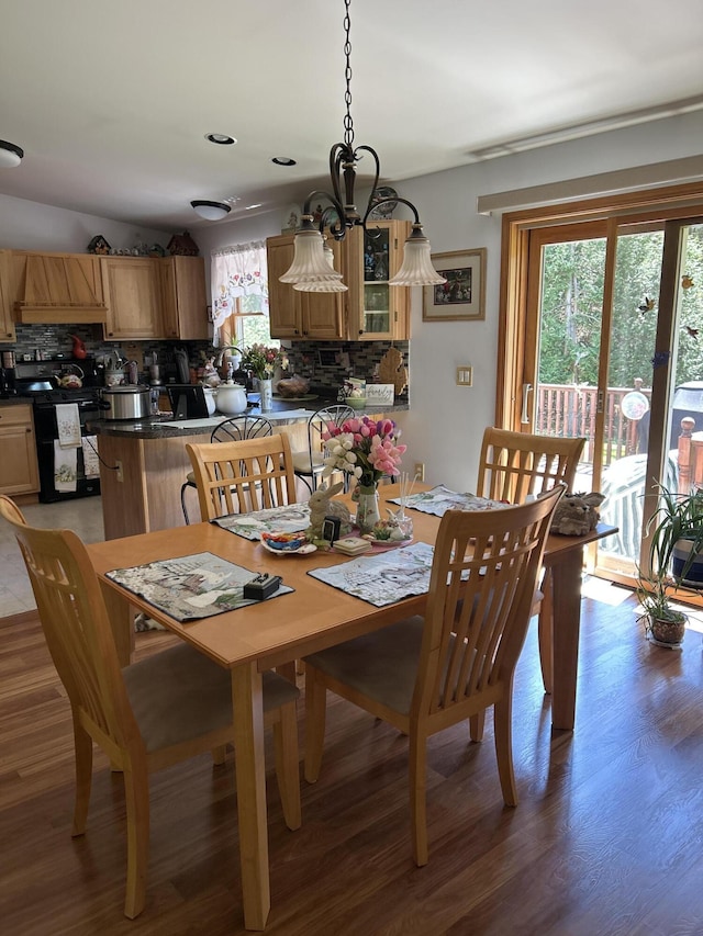 676 N Poor Farm Rd, Harrisville, MI 48740 - dining room featuring light wood-style floors and a chandelier