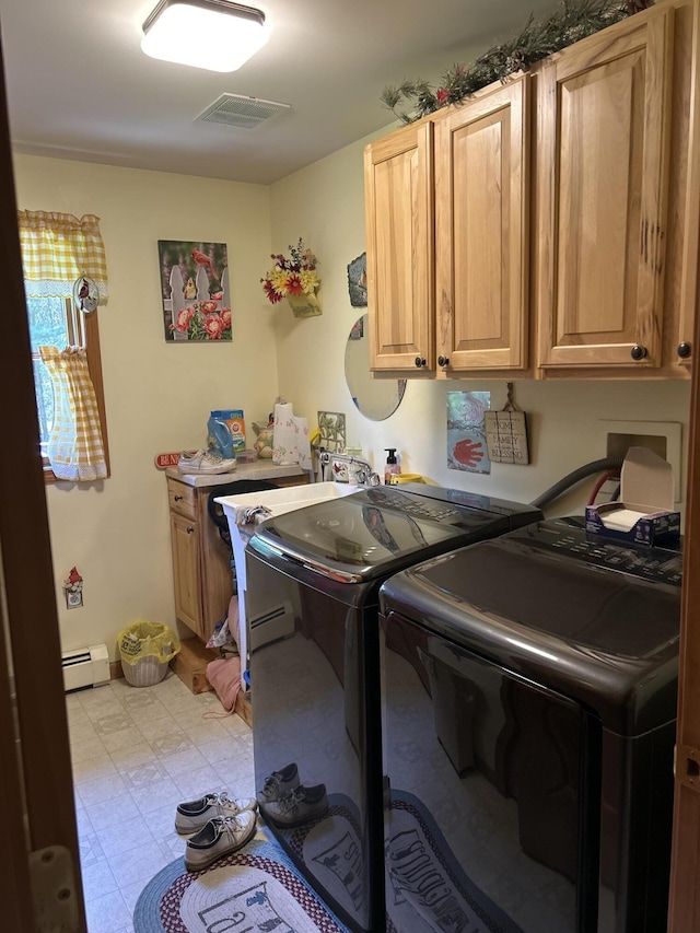 676 N Poor Farm Rd, Harrisville, MI 48740 - washroom featuring a baseboard heating unit, cabinet space, washing machine and dryer, and light flooring