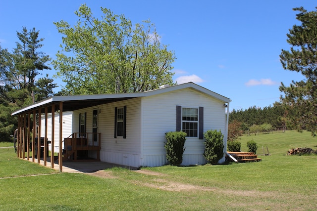 3071 Garling Rd, Fairview, MI 48621 - view of home's exterior featuring a yard and a carport