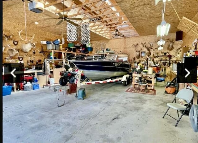2872 Granger Rd, Lewiston, MI 49756 - garage with a workshop area, a garage door opener, and ceiling fan