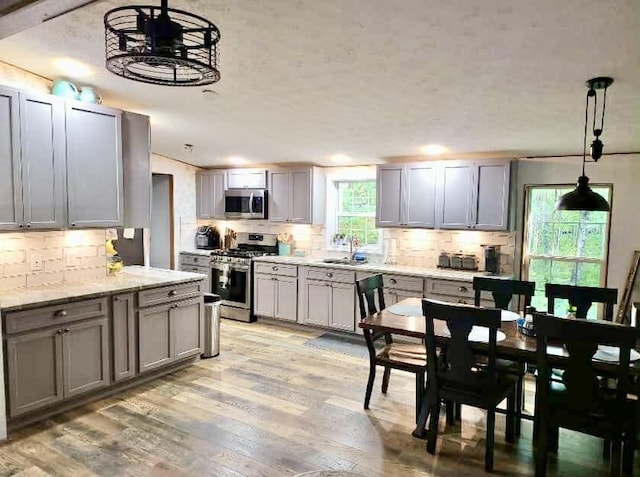 2872 Granger Rd, Lewiston, MI 49756 - kitchen featuring stainless steel appliances, tasteful backsplash, light wood-type flooring, and recessed lighting